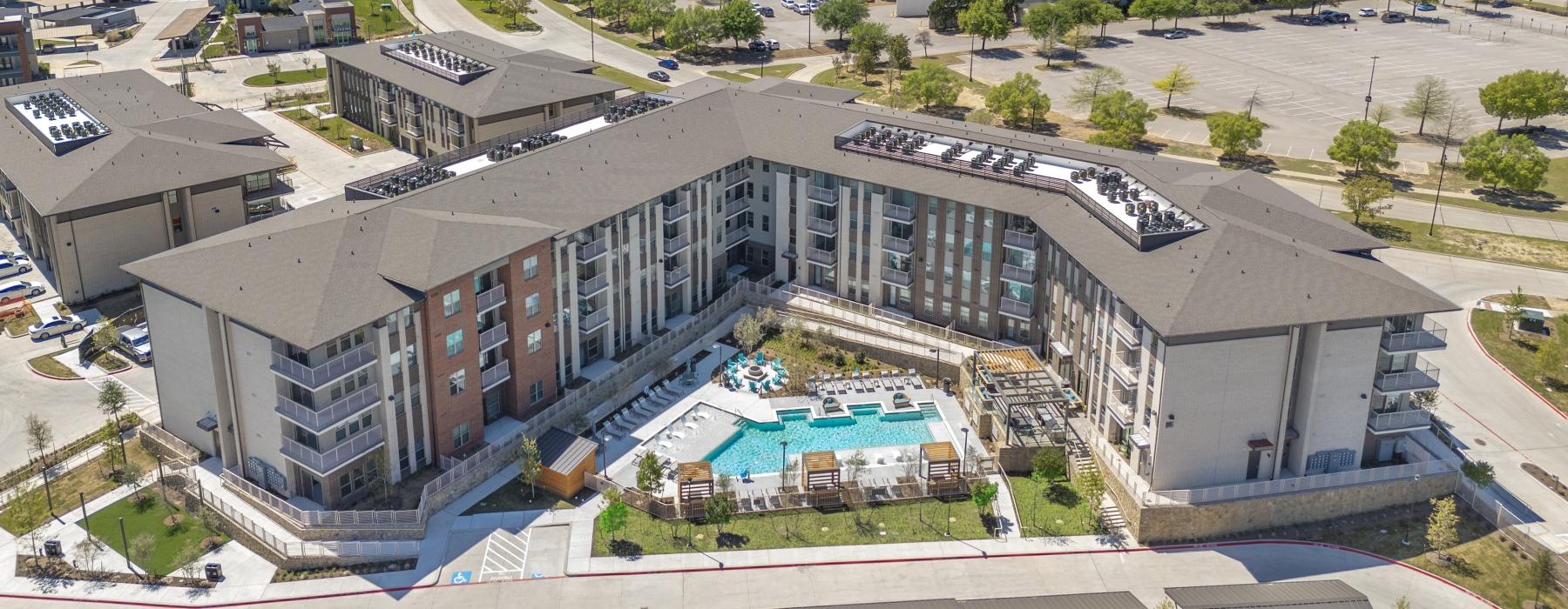aerial view of a large building with a pool