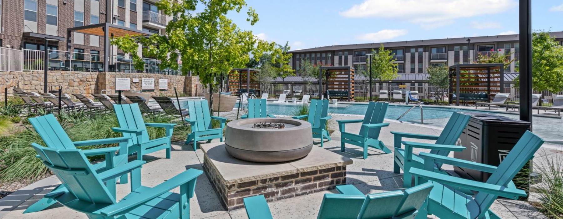 a group of chairs around a firepit